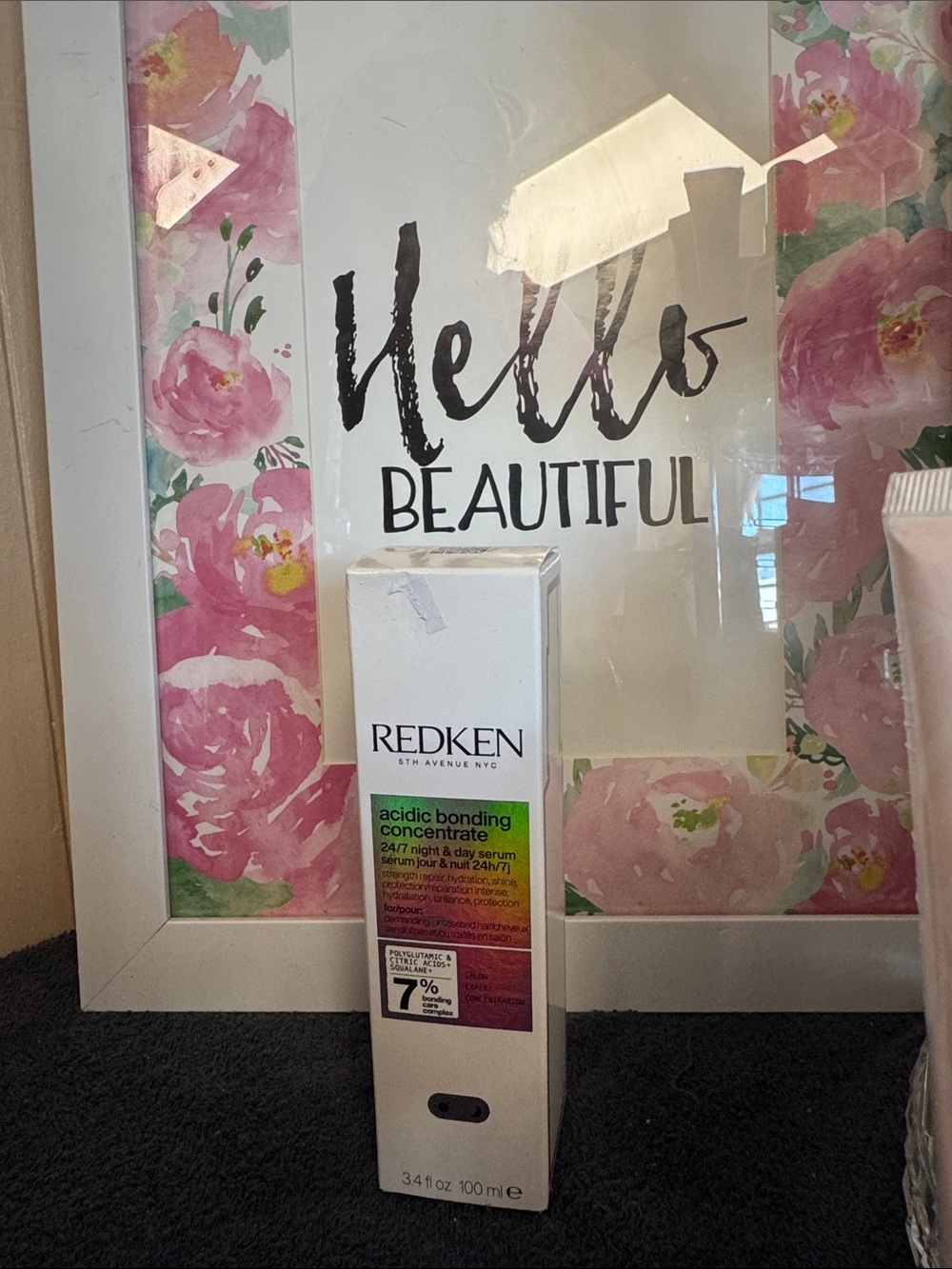Redken Acidic Bonding Concentrate in White Packaging with Pink Floral Accents